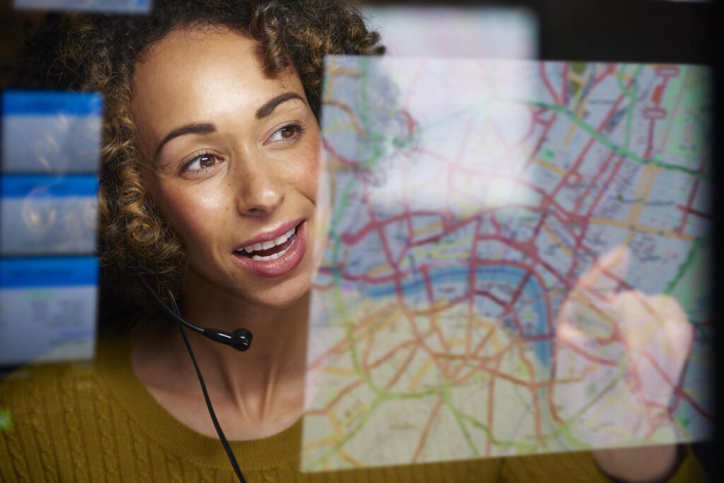 A call-taker undergoing an enhanced lecture training program component by looking at a map on a screen.