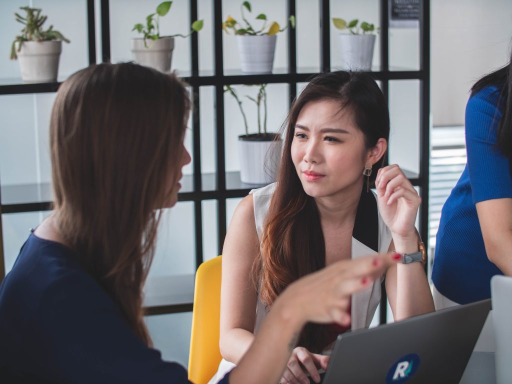 Two women having a conversation at work for informal learning. Credit: Unsplash / Mimi Thian